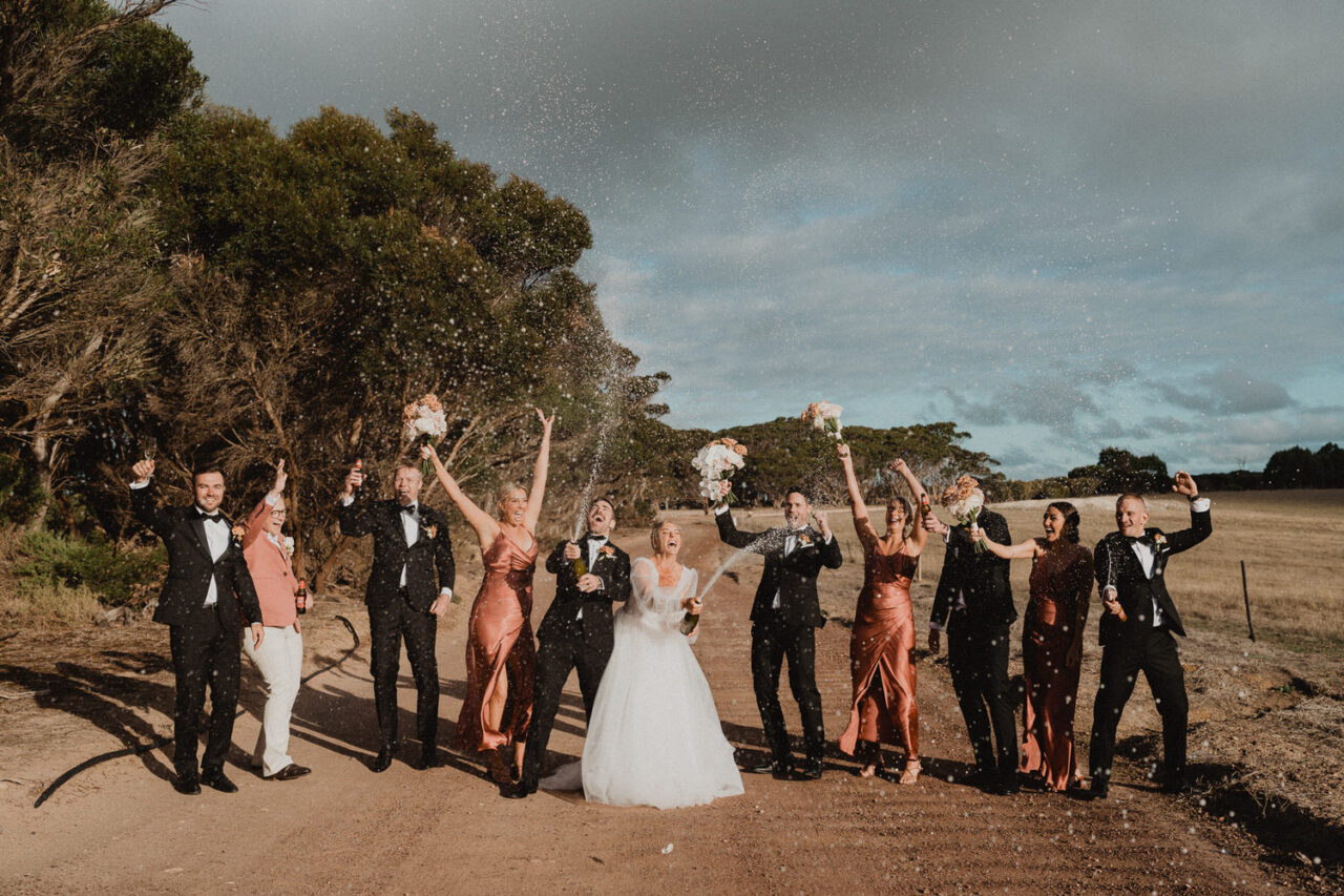 Wedding party spraying champagne at Dudley WInes on Kangaroo Island.