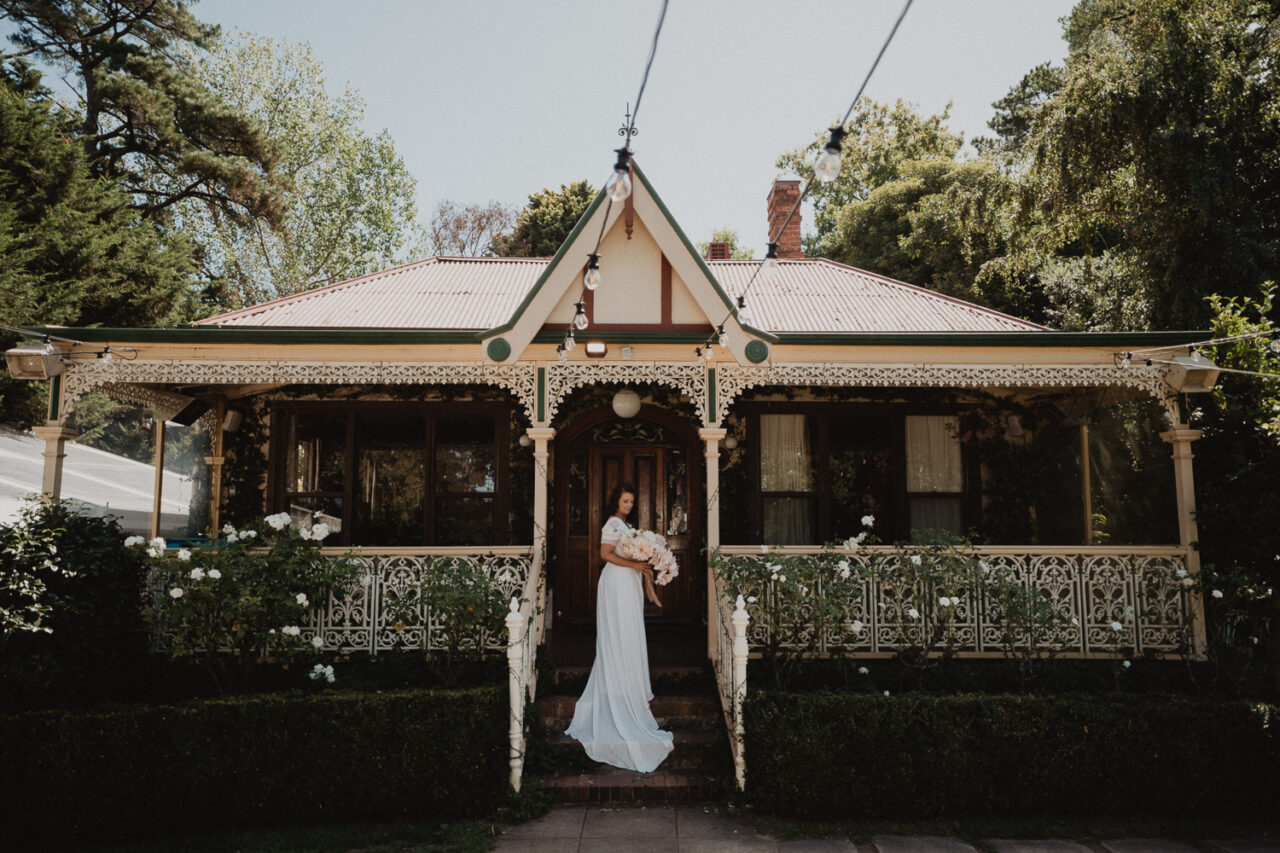 Bride on the steps of Templewood House before her wedding